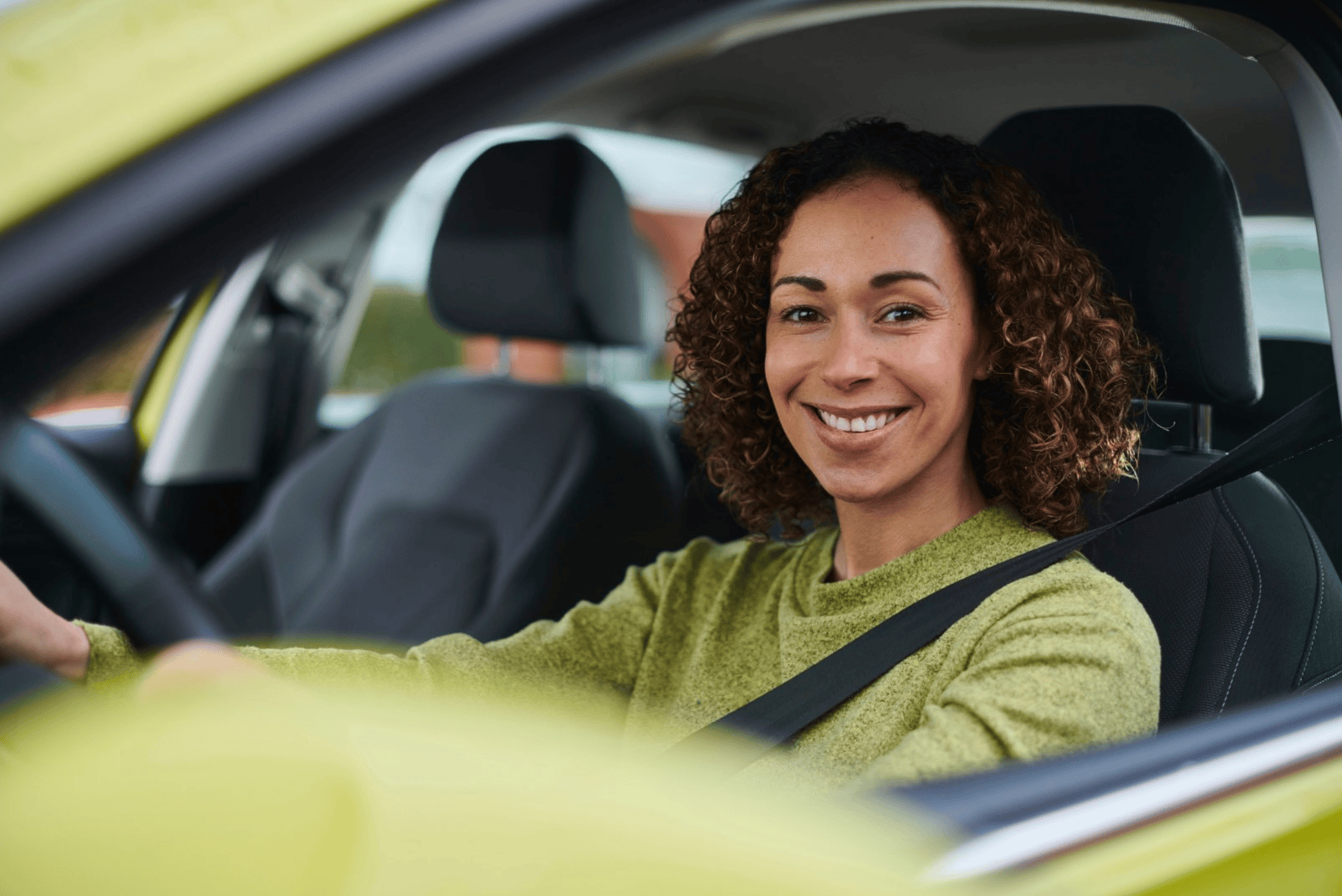 Driver wearing a seatbelt behind the wheel